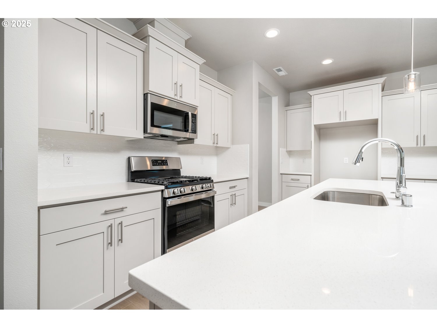 8900 South 1st Street, Unit 17 Ridgefield, WA 98642 - Photo 6 of 19 a kitchen with stainless steel appliances granite countertop a sink a stove a microwave and cabinets