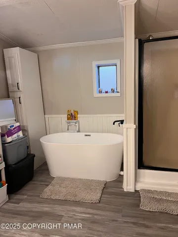 a living room with furniture a flat screen tv and a mirror