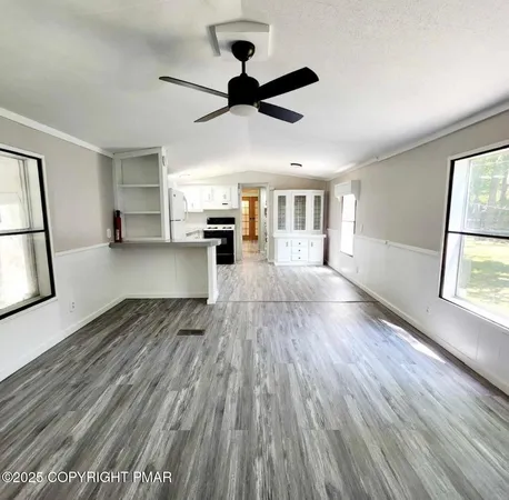 a kitchen with granite countertop white cabinets and white appliances