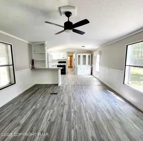 a kitchen with granite countertop white cabinets and white appliances