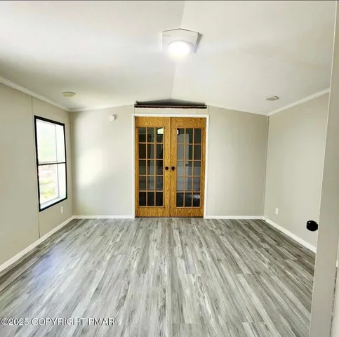 a view of a room with wooden floor and cabinet