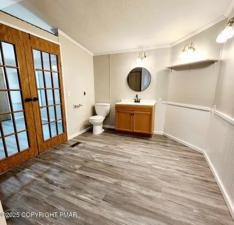 a view of a room with wooden floor and cabinet