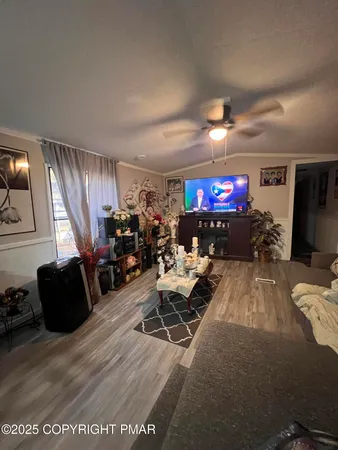 a living room with furniture a flat screen tv and a fireplace