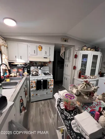 a kitchen with a stove a refrigerator and a stove