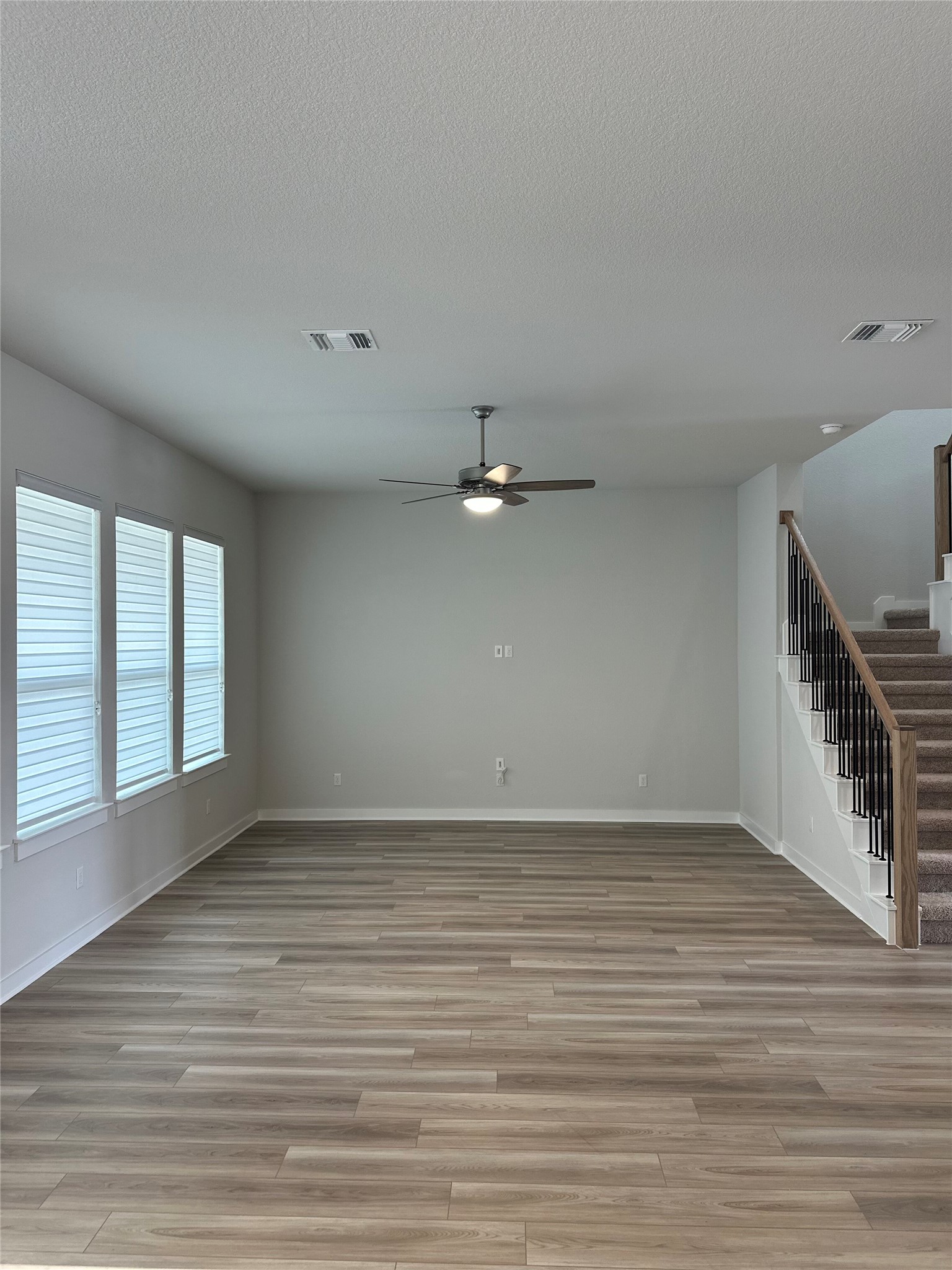 412 Lariat Loop Liberty Hill, TX 78642 - Photo 11 of 38 wooden floor in an empty room with a window