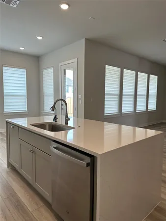 a kitchen with stainless steel appliances a refrigerator sink and microwave