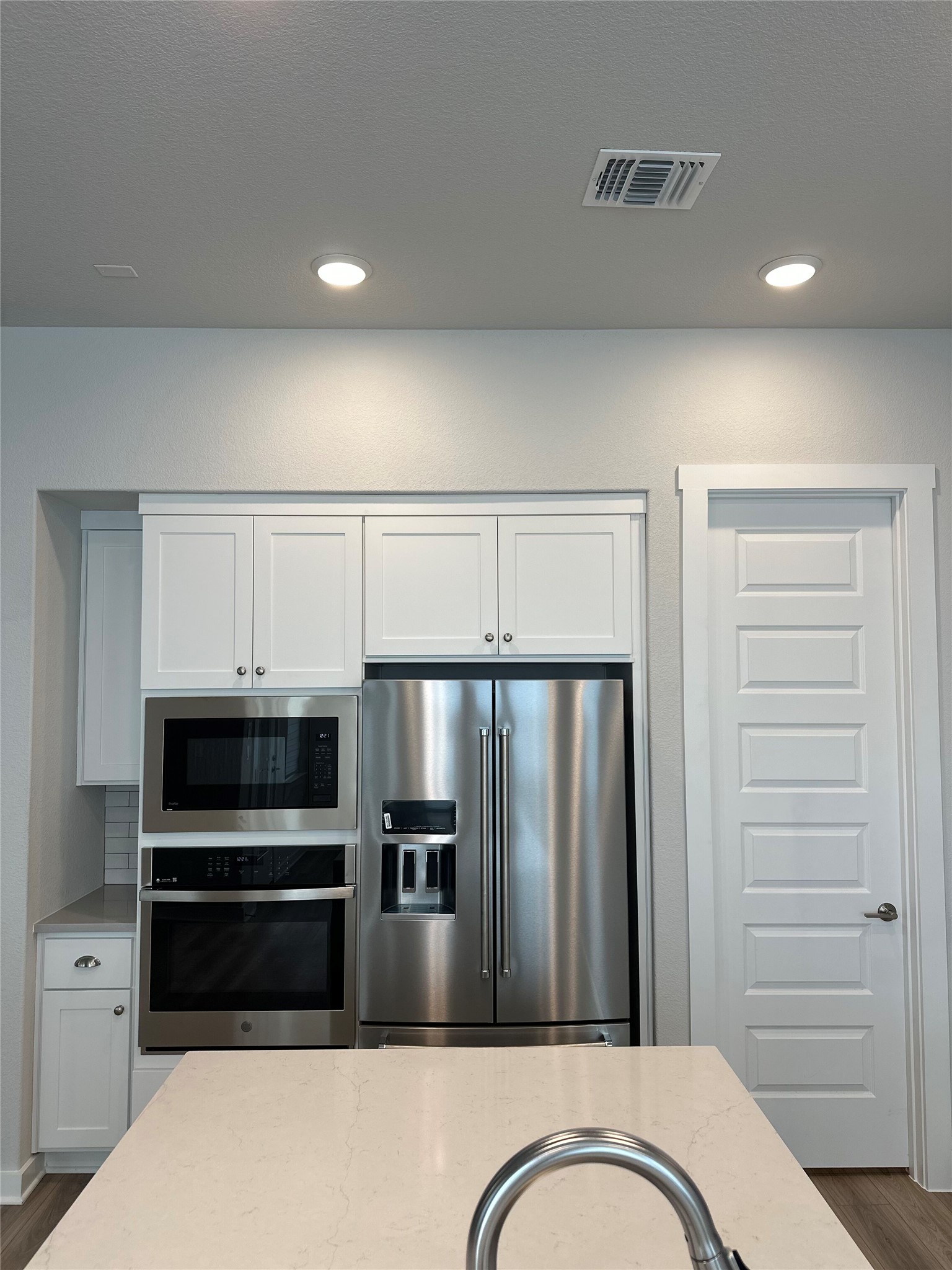 412 Lariat Loop Liberty Hill, TX 78642 - Photo 19 of 38 a kitchen with granite countertop a refrigerator and cabinets