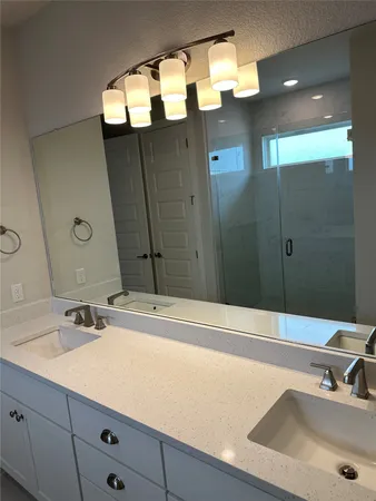 a bathroom with a sink double vanity and a mirror