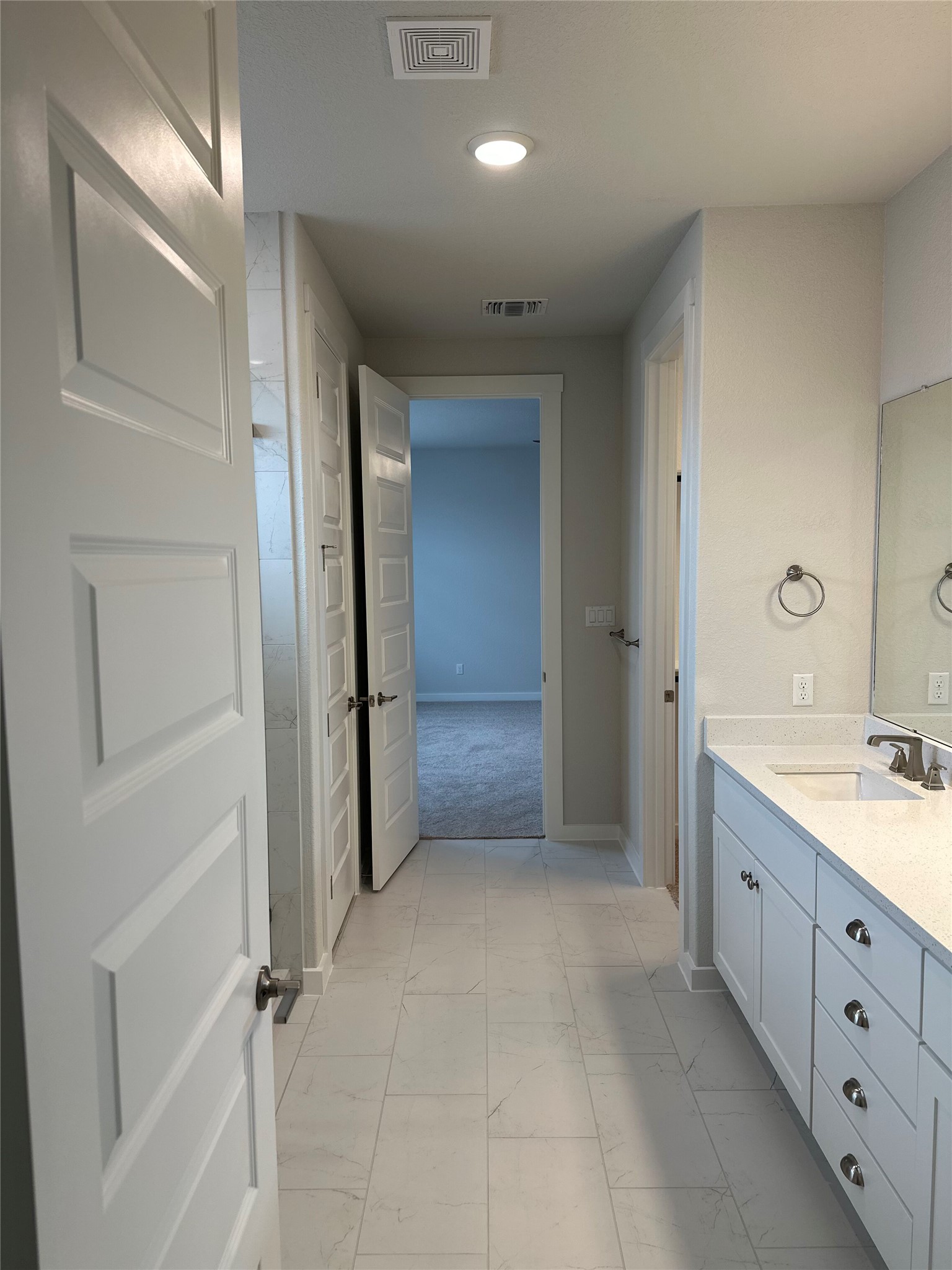 412 Lariat Loop Liberty Hill, TX 78642 - Photo 23 of 38 Bathroom with marble finish floor, vanity, visible vents, and baseboards