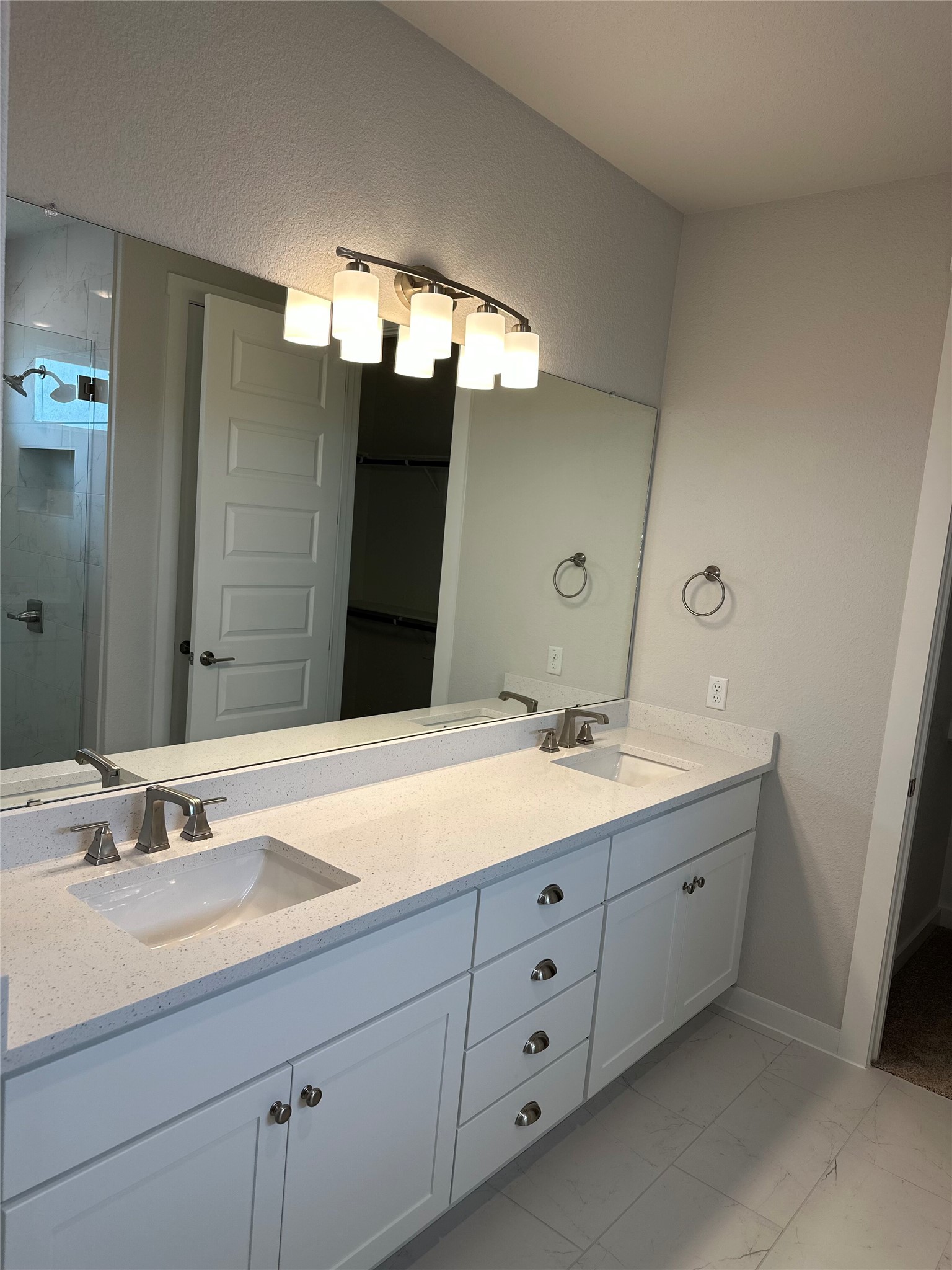 412 Lariat Loop Liberty Hill, TX 78642 - Photo 25 of 38 a bathroom with a double vanity sink and mirror