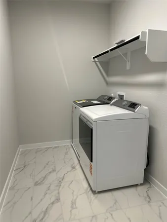 a big white house with a big yard and large trees