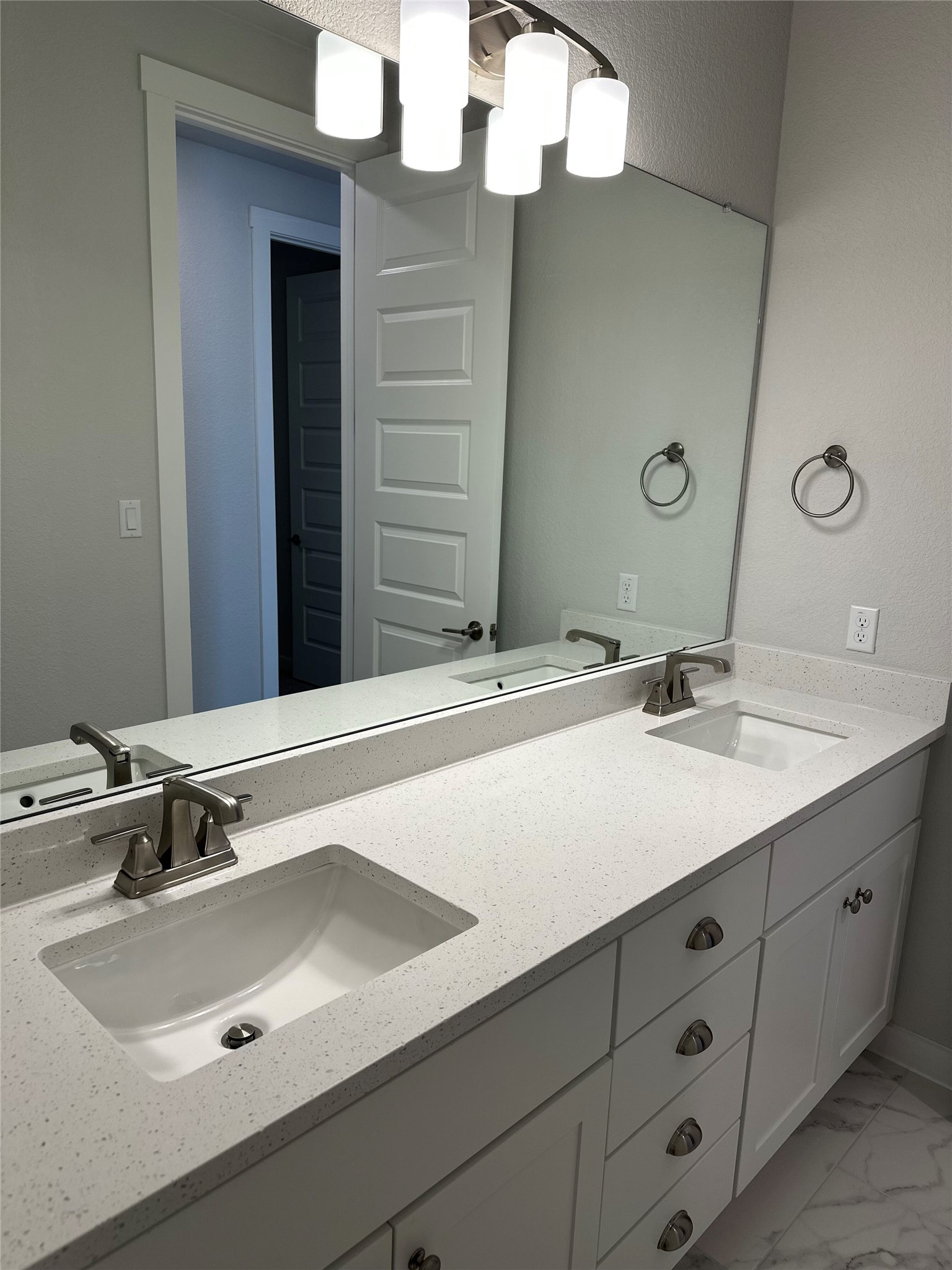 412 Lariat Loop Liberty Hill, TX 78642 - Photo 33 of 38 Bathroom with marble finish floor, double vanity, and a sink
