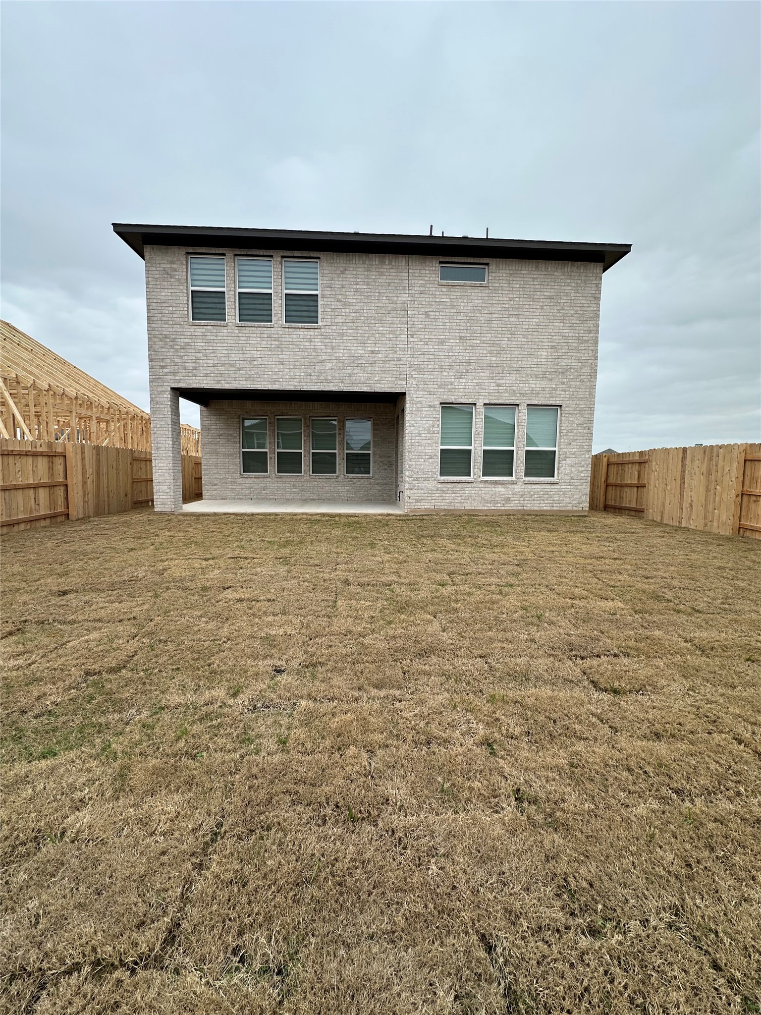 412 Lariat Loop Liberty Hill, TX 78642 - Photo 37 of 38 Back of house featuring a lawn, a patio area, and a fenced backyard