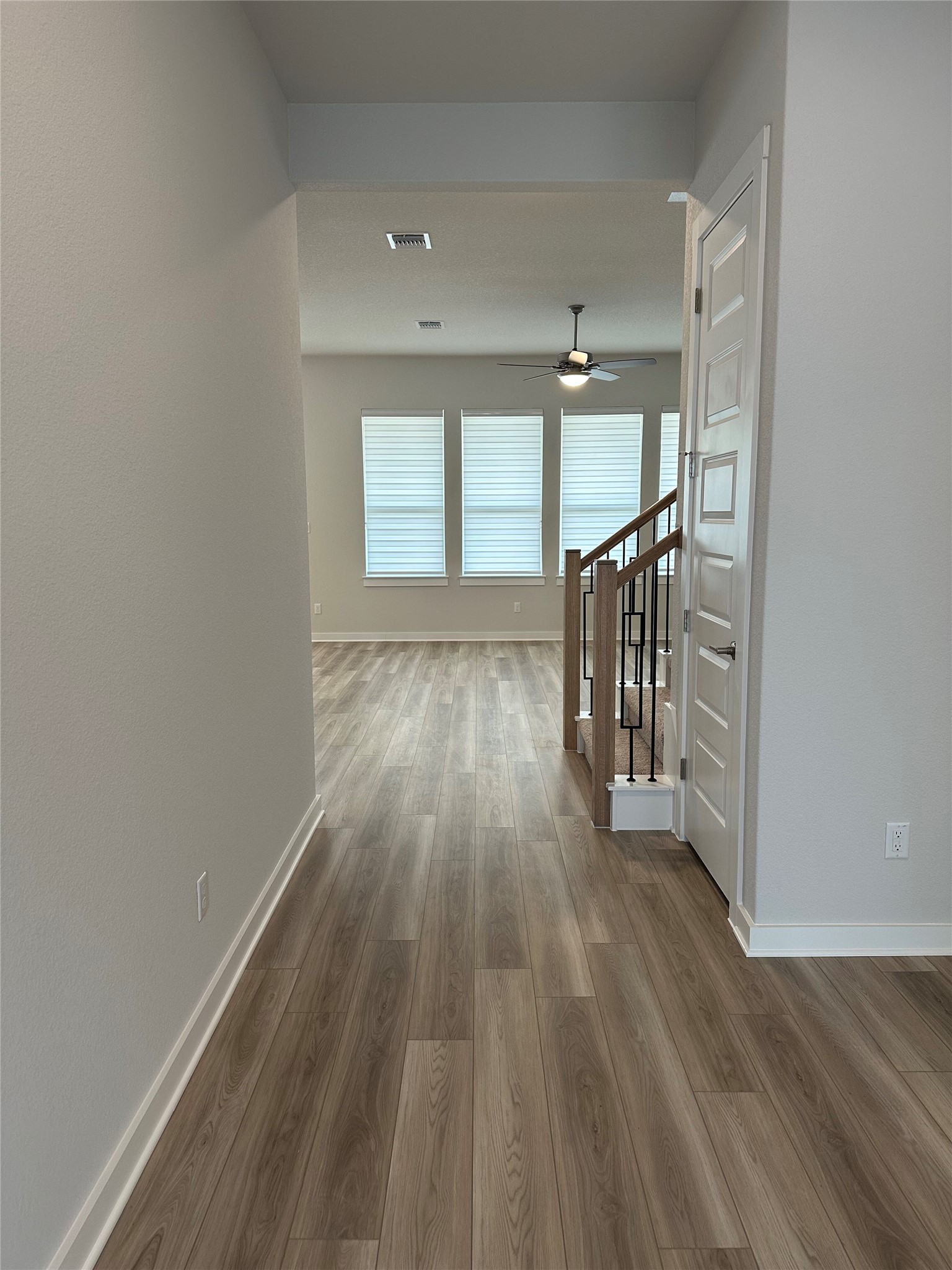 412 Lariat Loop Liberty Hill, TX 78642 - Photo 4 of 38 wooden floor in an empty room with a window