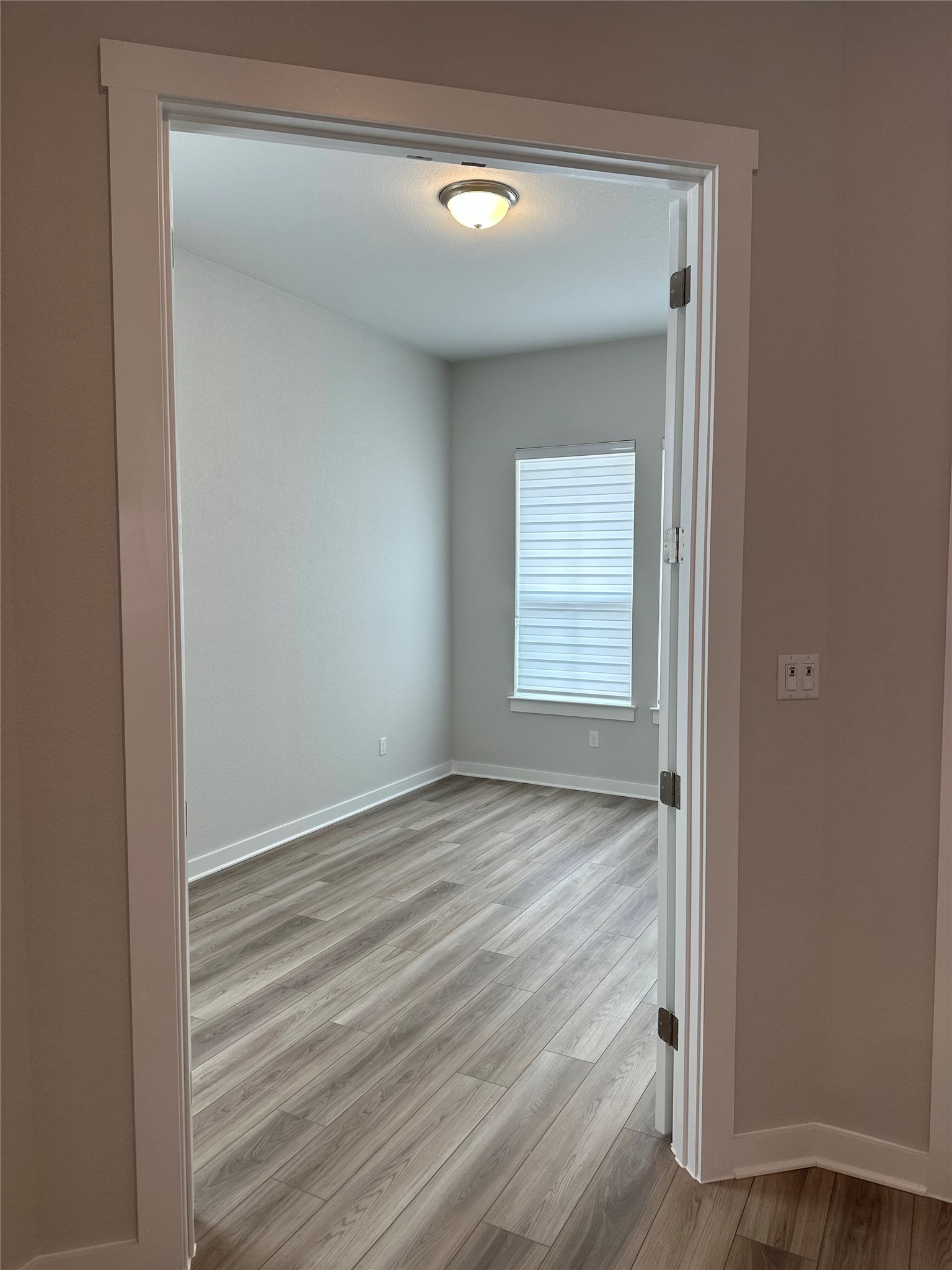 412 Lariat Loop Liberty Hill, TX 78642 - Photo 5 of 38 Empty room with light wood-style flooring and baseboards