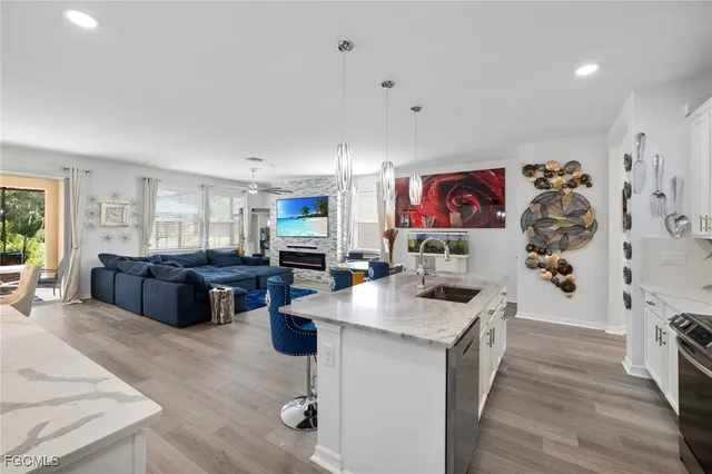 a living room with furniture dining table and wooden floor