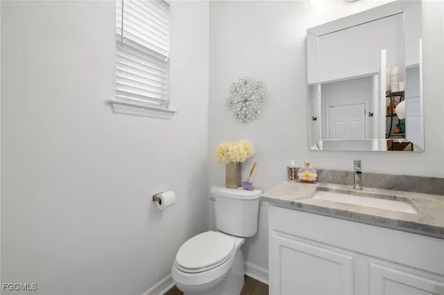 a living room with furniture and wall paintings