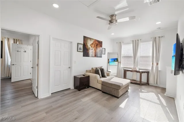 a spacious bedroom with furniture and a large window