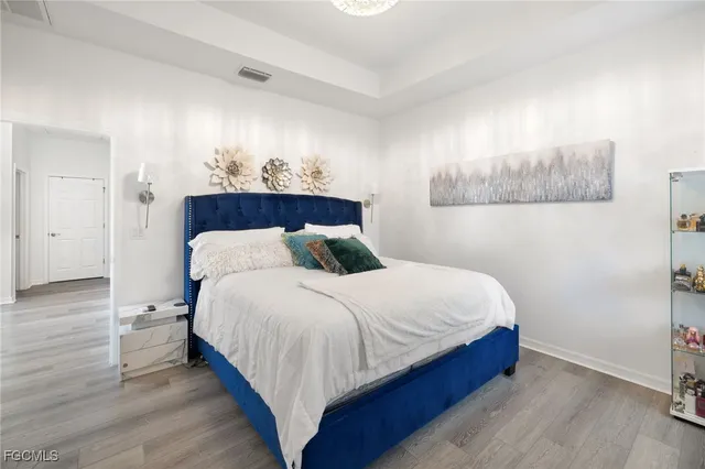 a bedroom with a large bed and a wooden cabinets