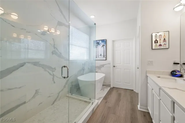 a bathroom with a double vanity sink a toilet and shower
