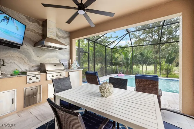 a view of a patio with a table chairs and a floor to ceiling window