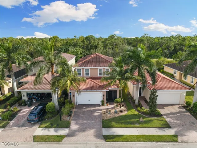 an aerial view of residential houses with outdoor space and lake view