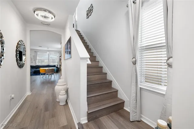 a view of entryway and hall with wooden floor