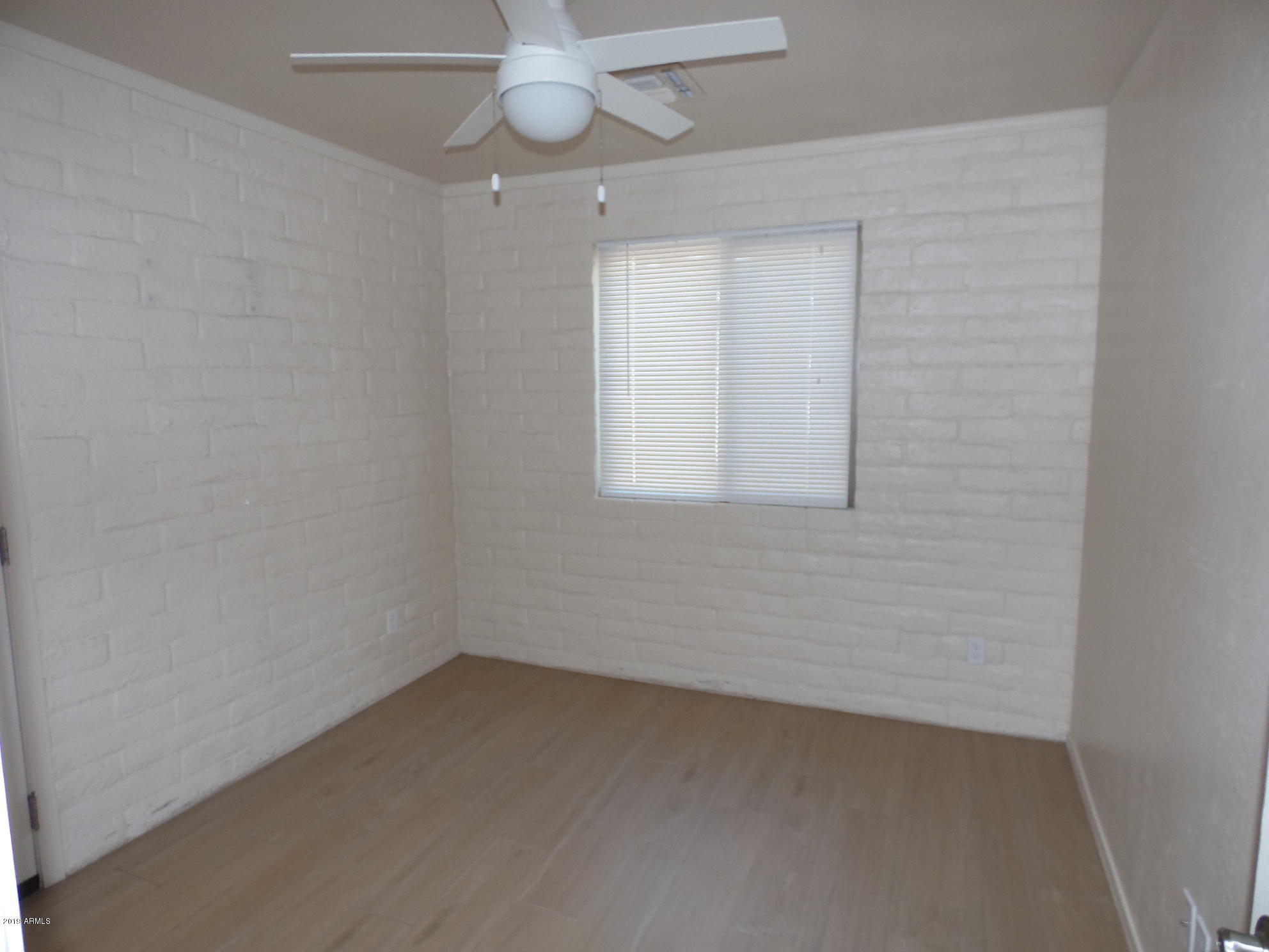438 South Hobson, Unit 442 Mesa, AZ 85204 - Photo 7 of 7 an empty room with a window and a fan