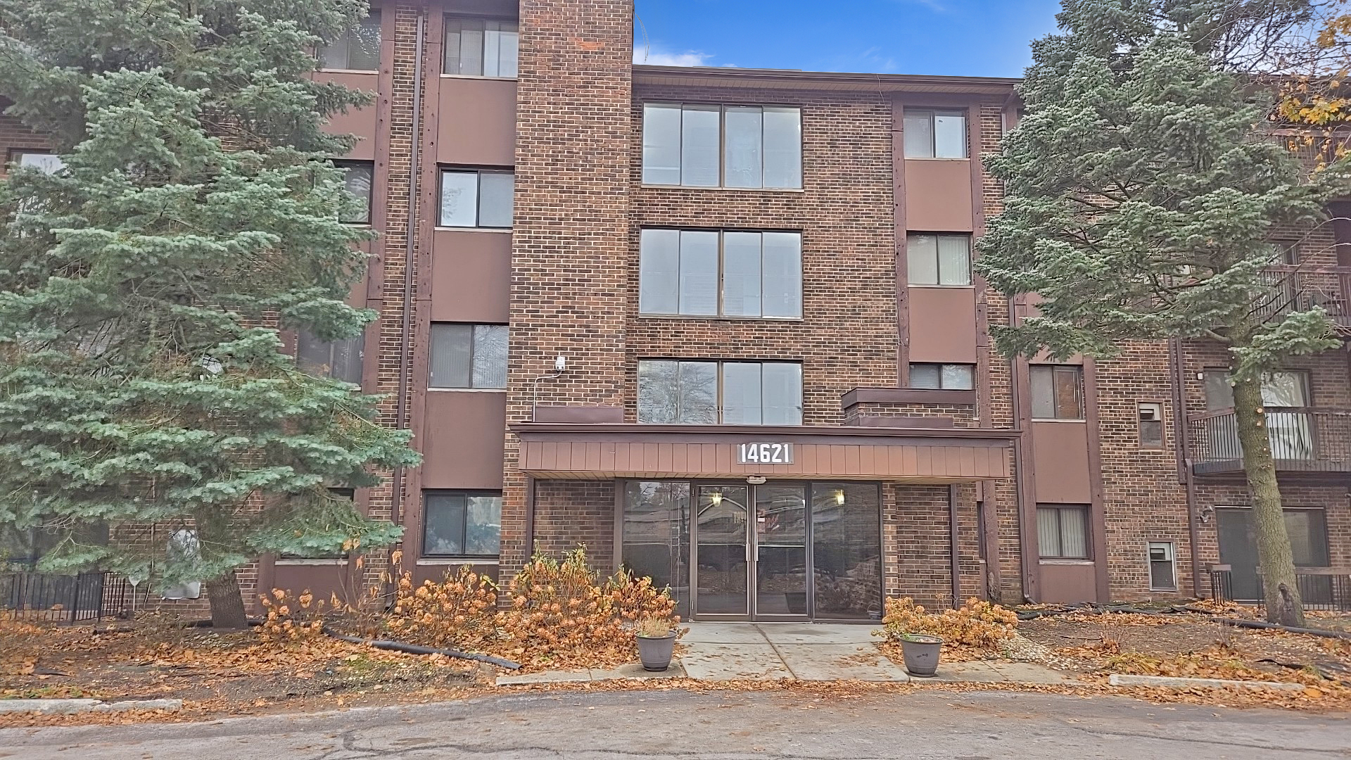 a front view of a building with a garden
