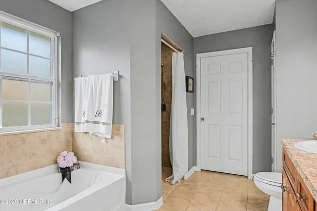 a bathroom with a tub and shower