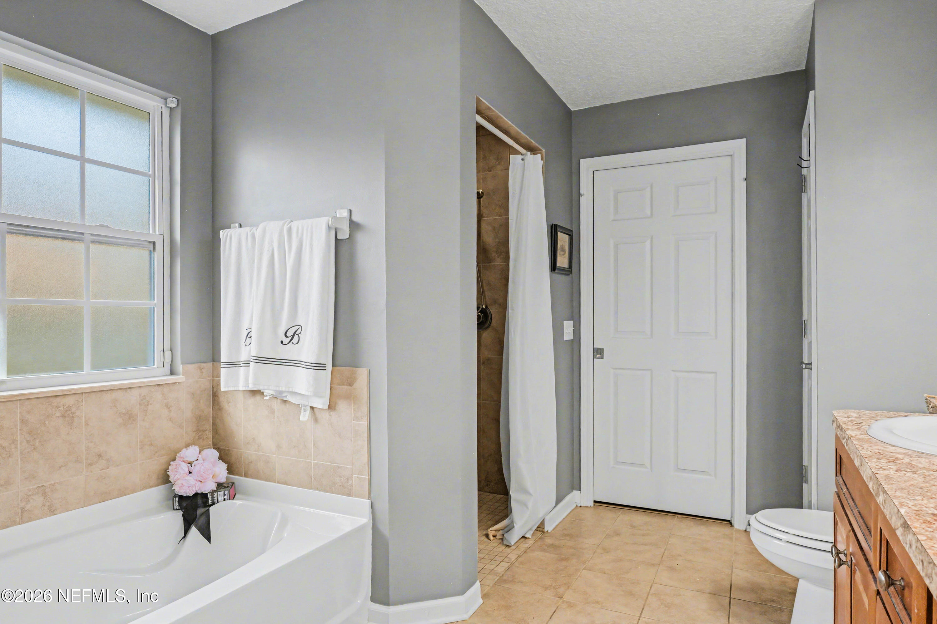 87159 Chesapeake Avenue Yulee, FL 32097 - Photo 19 of 46 a bathroom with a tub and shower