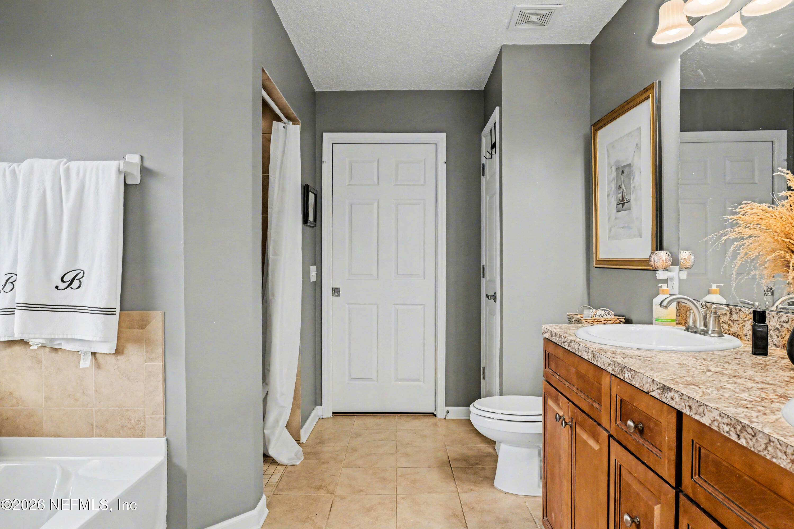 87159 Chesapeake Avenue Yulee, FL 32097 - Photo 21 of 46 a bathroom with a granite countertop sink toilet and shower