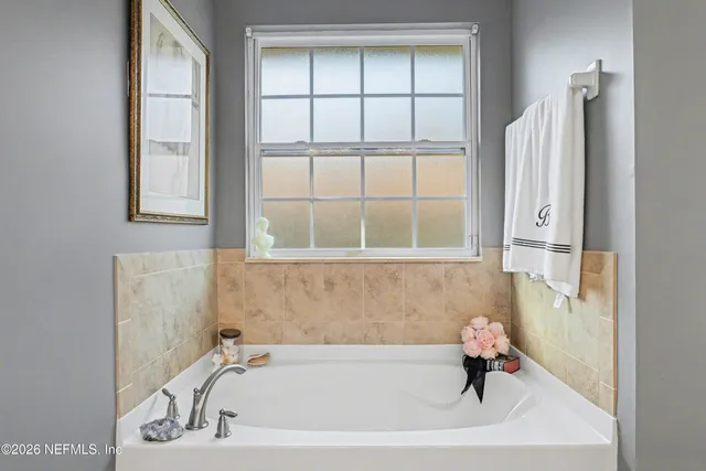 a bath tub sitting next to a window