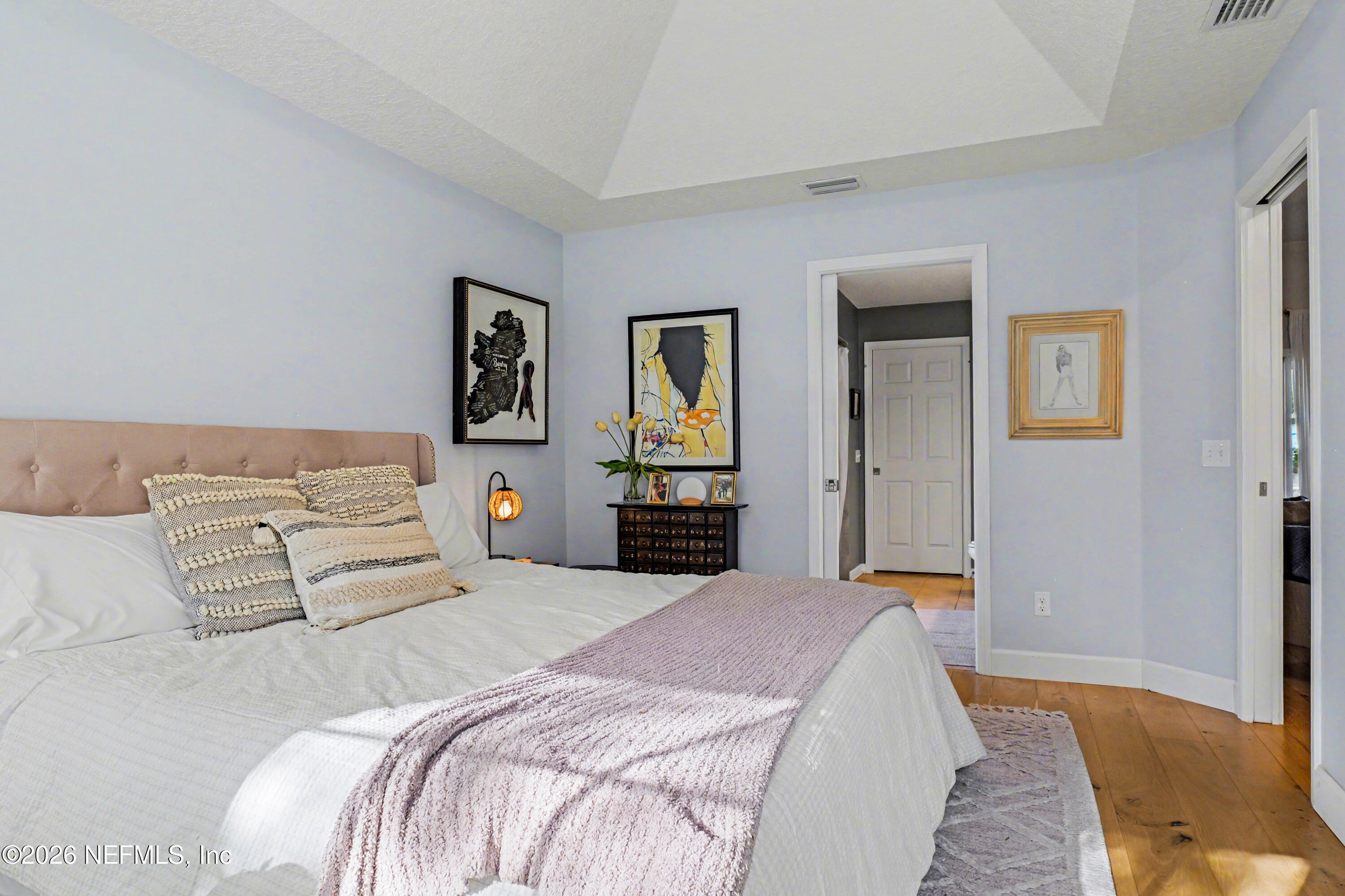 87159 Chesapeake Avenue Yulee, FL 32097 - Photo 24 of 46 a bedroom with a large bed and dresser