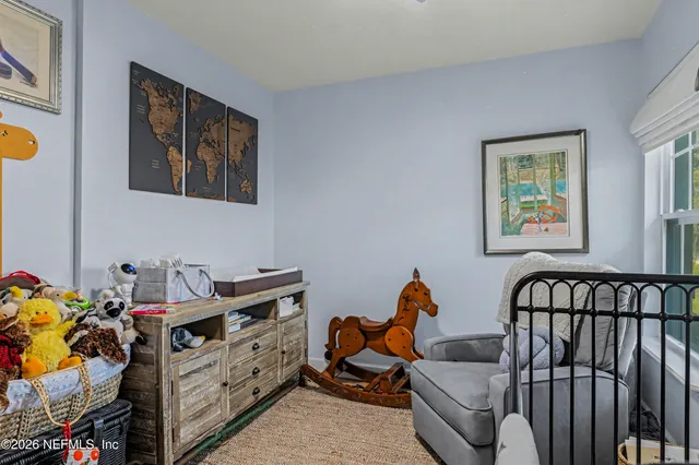 a bedroom with furniture toys and a window