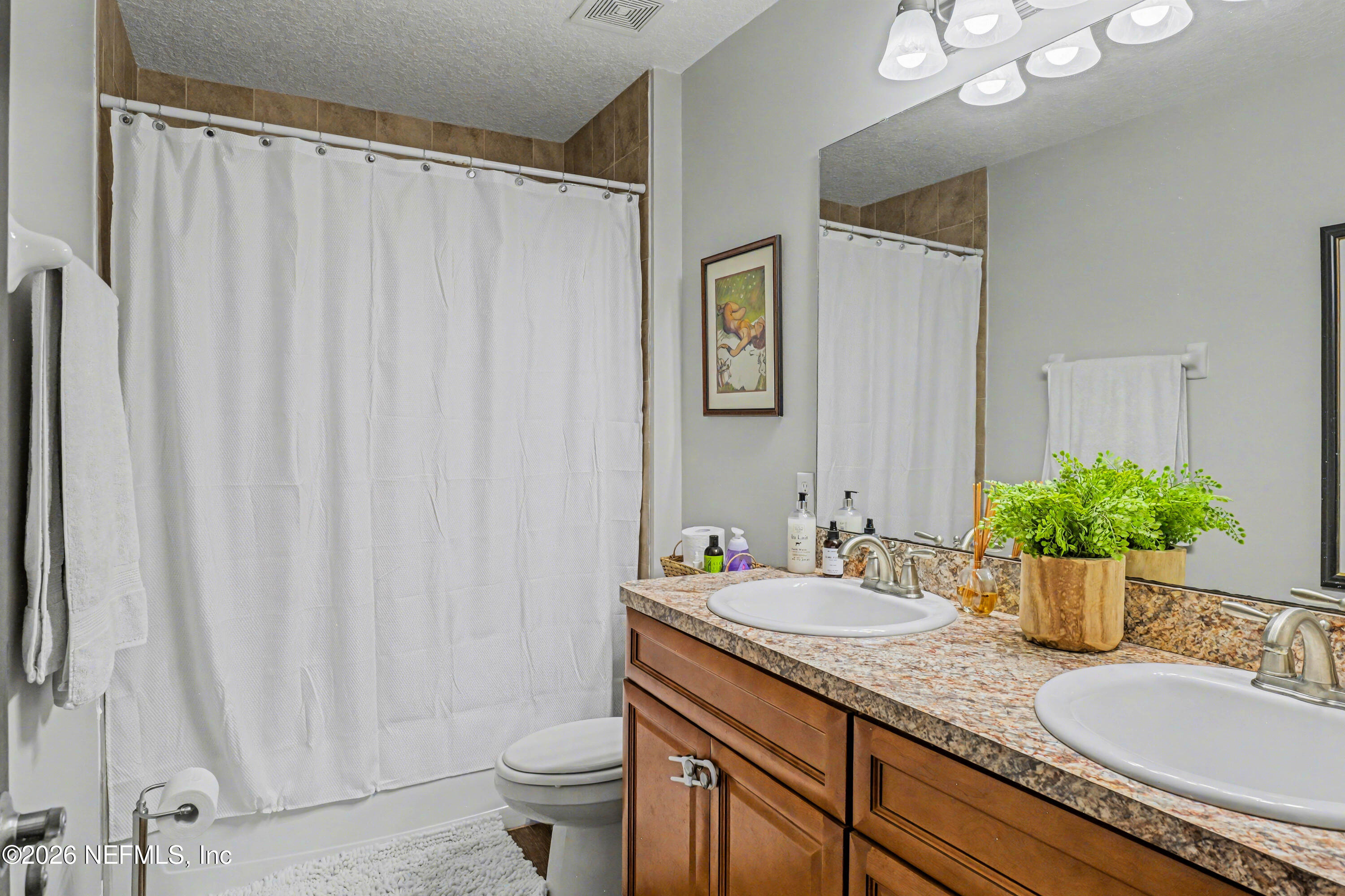 87159 Chesapeake Avenue Yulee, FL 32097 - Photo 37 of 46 a bathroom with a granite countertop sink and a mirror