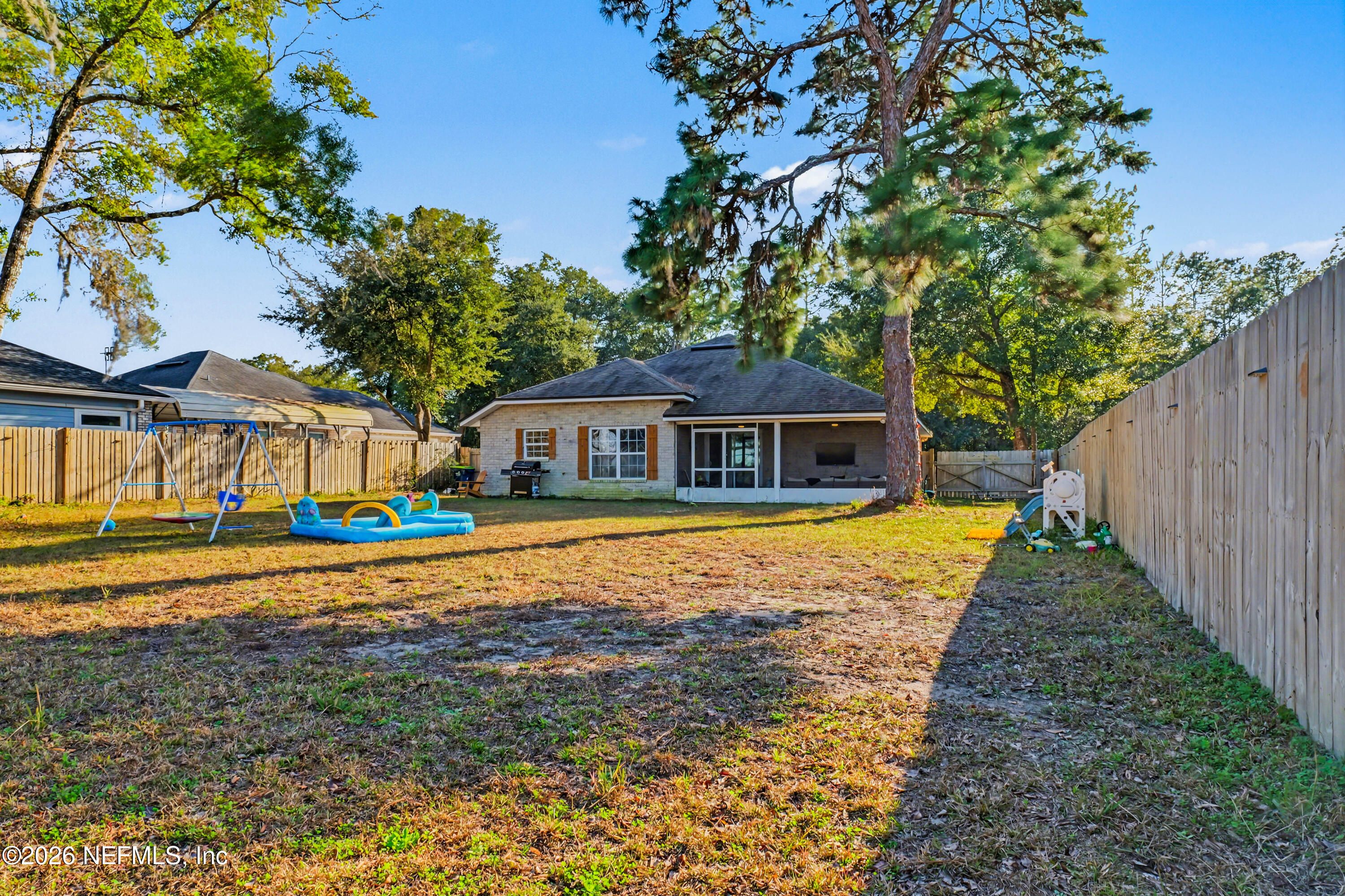 87159 Chesapeake Avenue Yulee, FL 32097 - Photo 42 of 46 a front view of house with yard and trees in the background