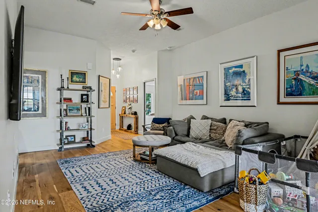 a living room with furniture and wooden floor