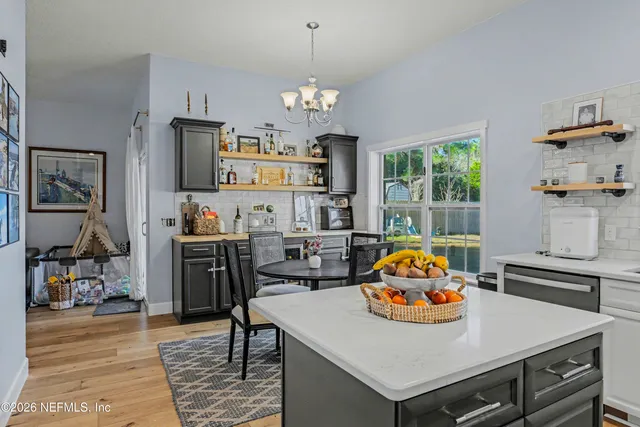 a view of kitchen island with furniture and chandelier