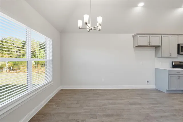 a view of a kitchen with a dishwasher cabinets and a large window