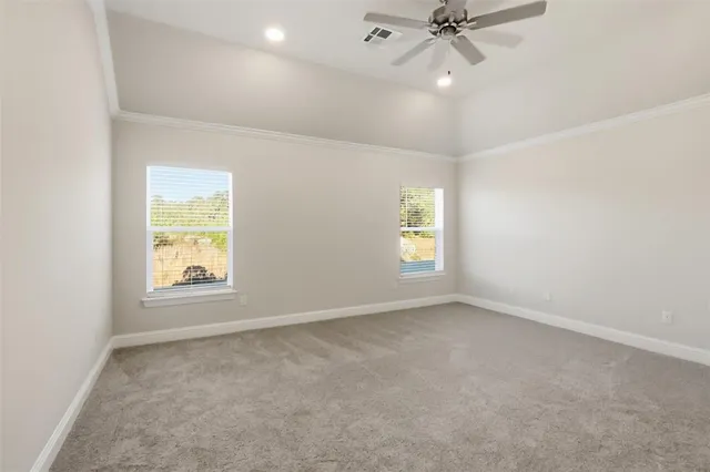 an empty room with a window and a ceiling fan