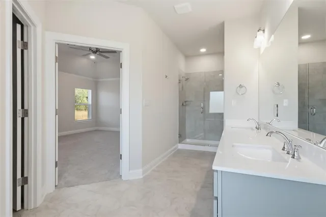 a bathroom with a sink shower and a mirror