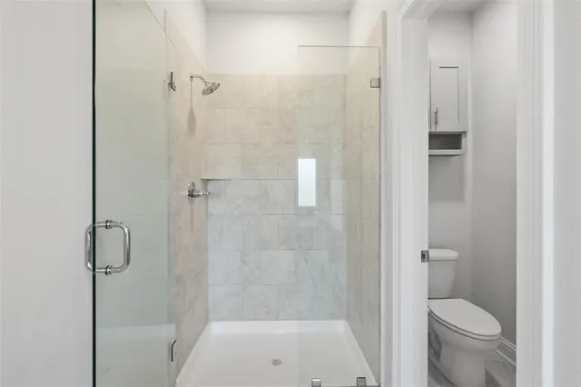 a bathroom with a granite countertop toilet