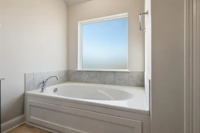 a white bath tub sitting next to a white sink