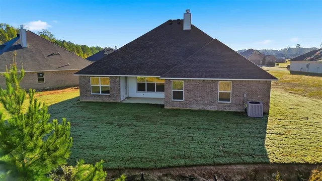 a aerial view of a house next to a yard