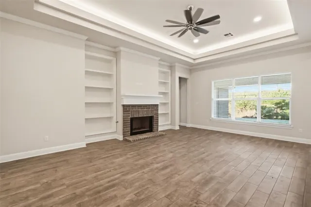 wooden floor in an empty room with a fireplace