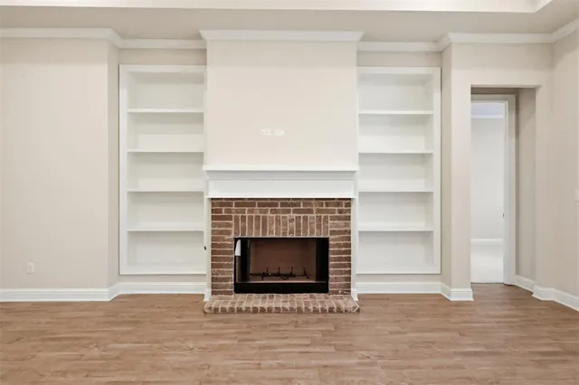 a living room with a fireplace and a walk in closet