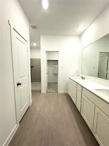 a bathroom with a double vanity sink and mirror