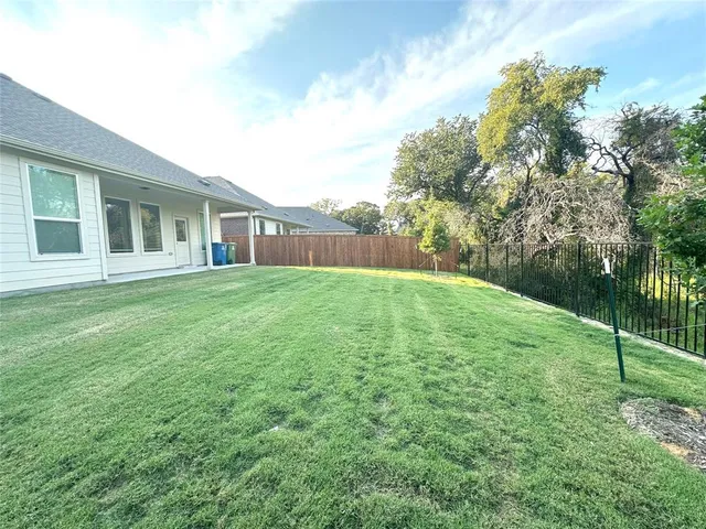 a backyard of a house with lots of green space
