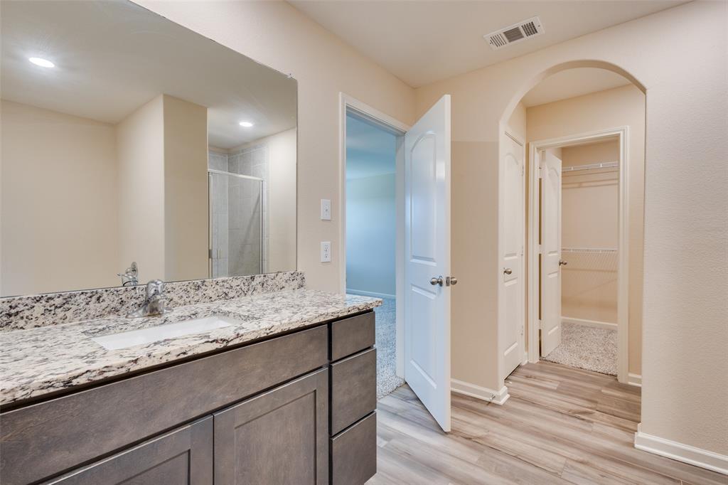2256 Cashmere Way Princeton, TX 75407 - Photo 19 of 36 a bathroom with a sink and a mirror